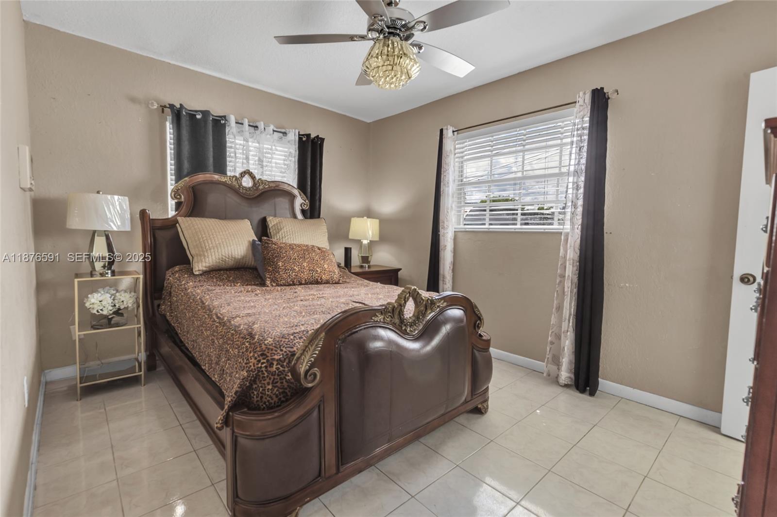 22270 Southwest 109th Avenue Miami, FL 33176 - Photo 20 of 48 a bedroom with a bed and a chandelier