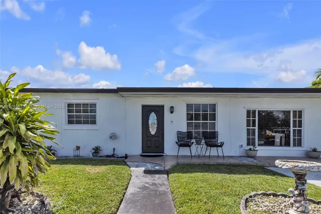 a view of a house with swimming pool and sitting area