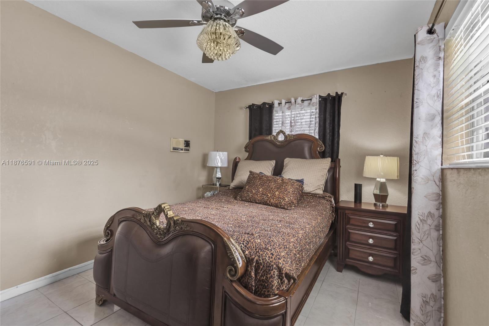 22270 Southwest 109th Avenue Miami, FL 33176 - Photo 23 of 48 a bedroom with a bed and a chandelier