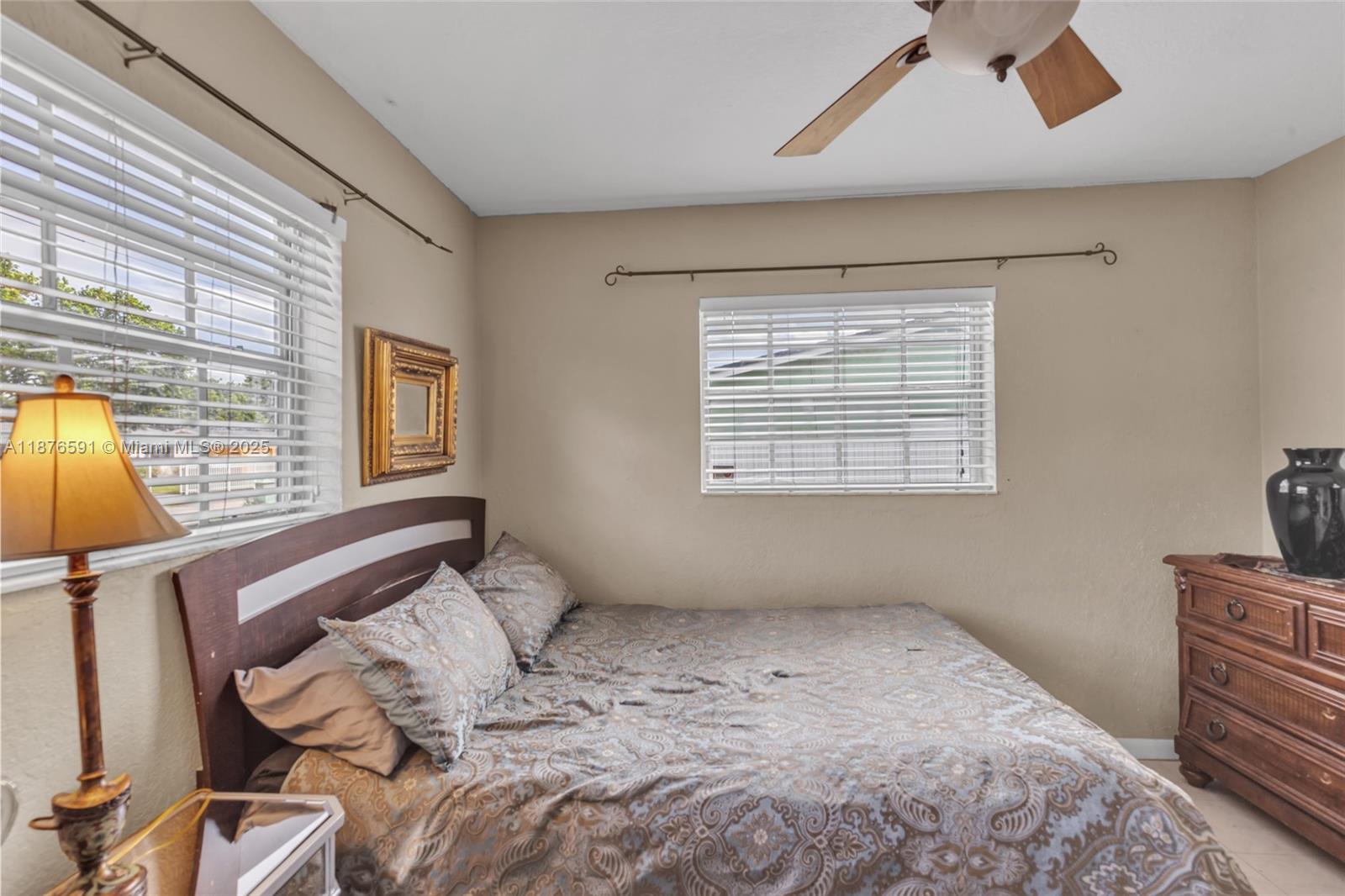 22270 Southwest 109th Avenue Miami, FL 33176 - Photo 25 of 48 a bedroom with a bed and wooden floor