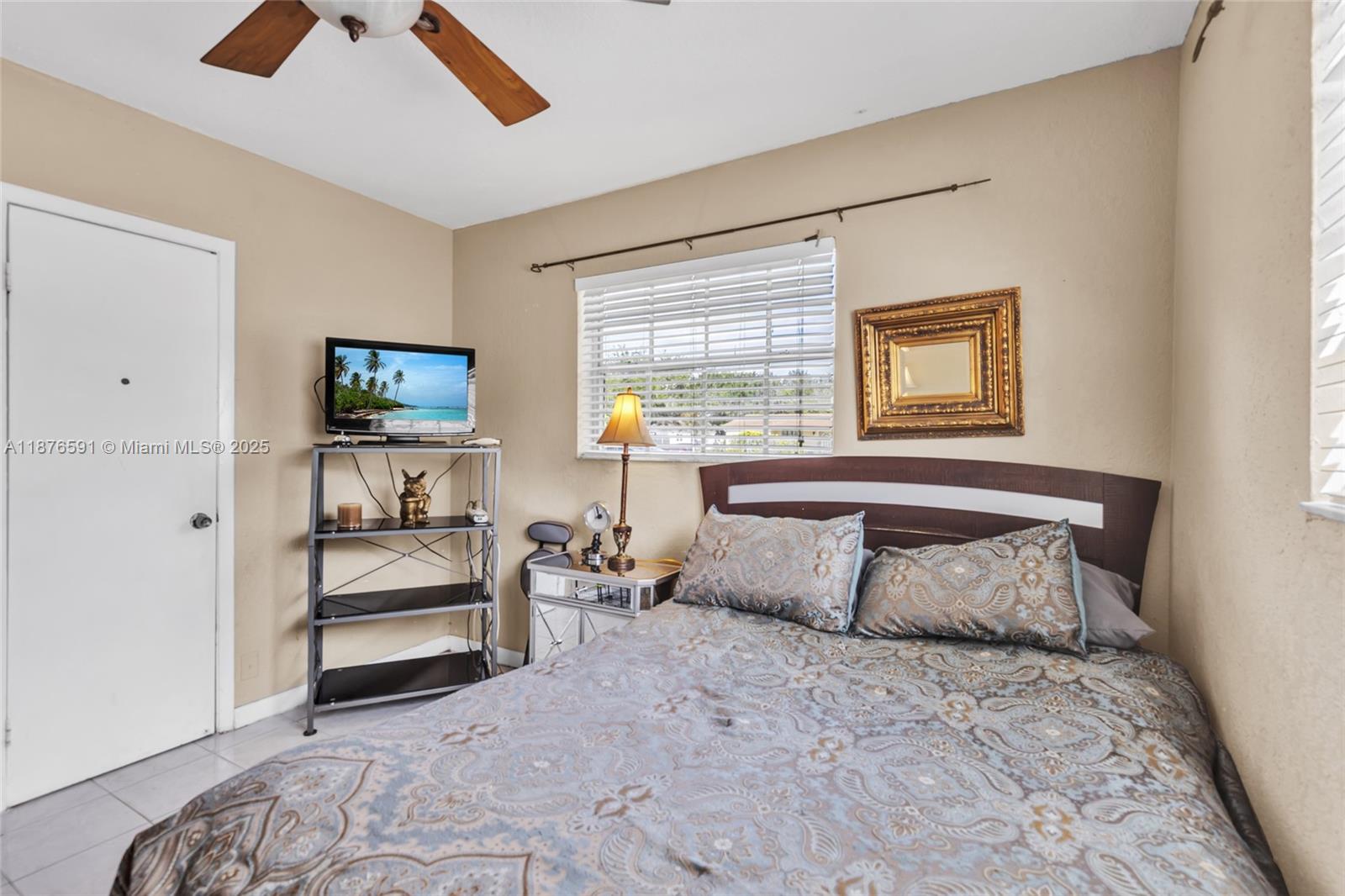 22270 Southwest 109th Avenue Miami, FL 33176 - Photo 26 of 48 a bedroom with a bed and a flat tv screen