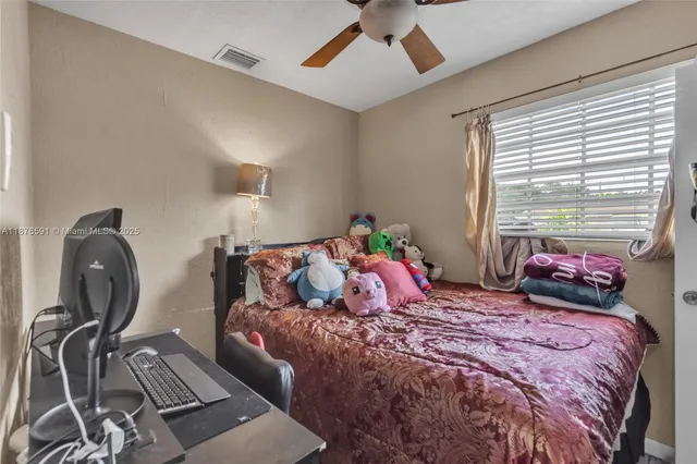 a bedroom with a bed and window