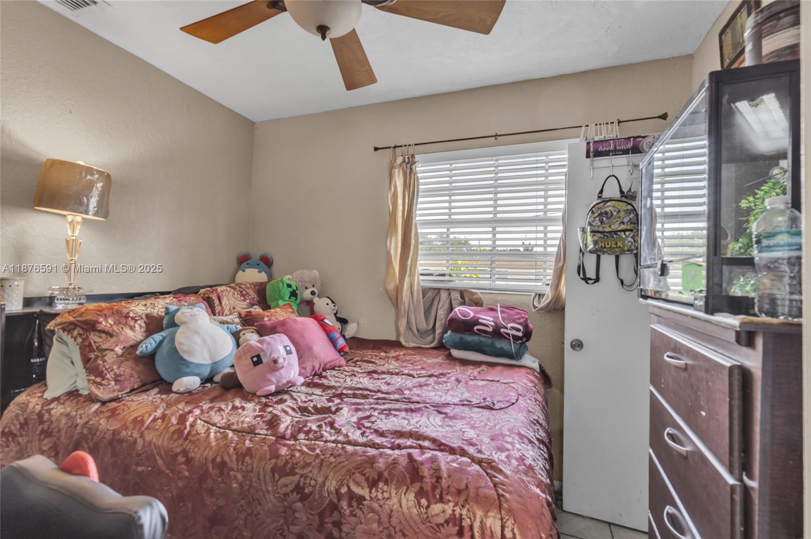 22270 Southwest 109th Avenue Miami, FL 33176 - Photo 28 of 48 a bedroom with a bed and window