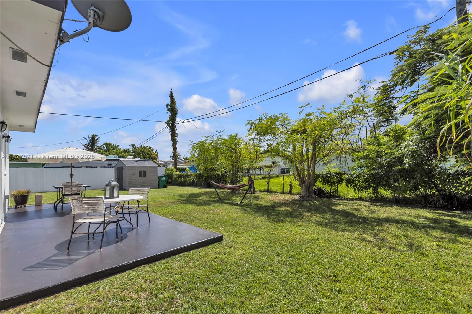 22270 Southwest 109th Avenue Miami, FL 33176 - Photo 40 of 48 a swimming pool with outdoor seating and yard