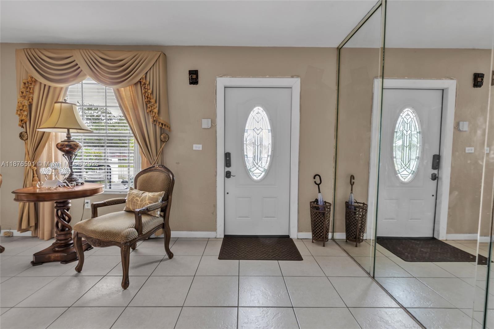 22270 Southwest 109th Avenue Miami, FL 33176 - Photo 4 of 48 a view of a hallway with entryway dining room and livingroom view