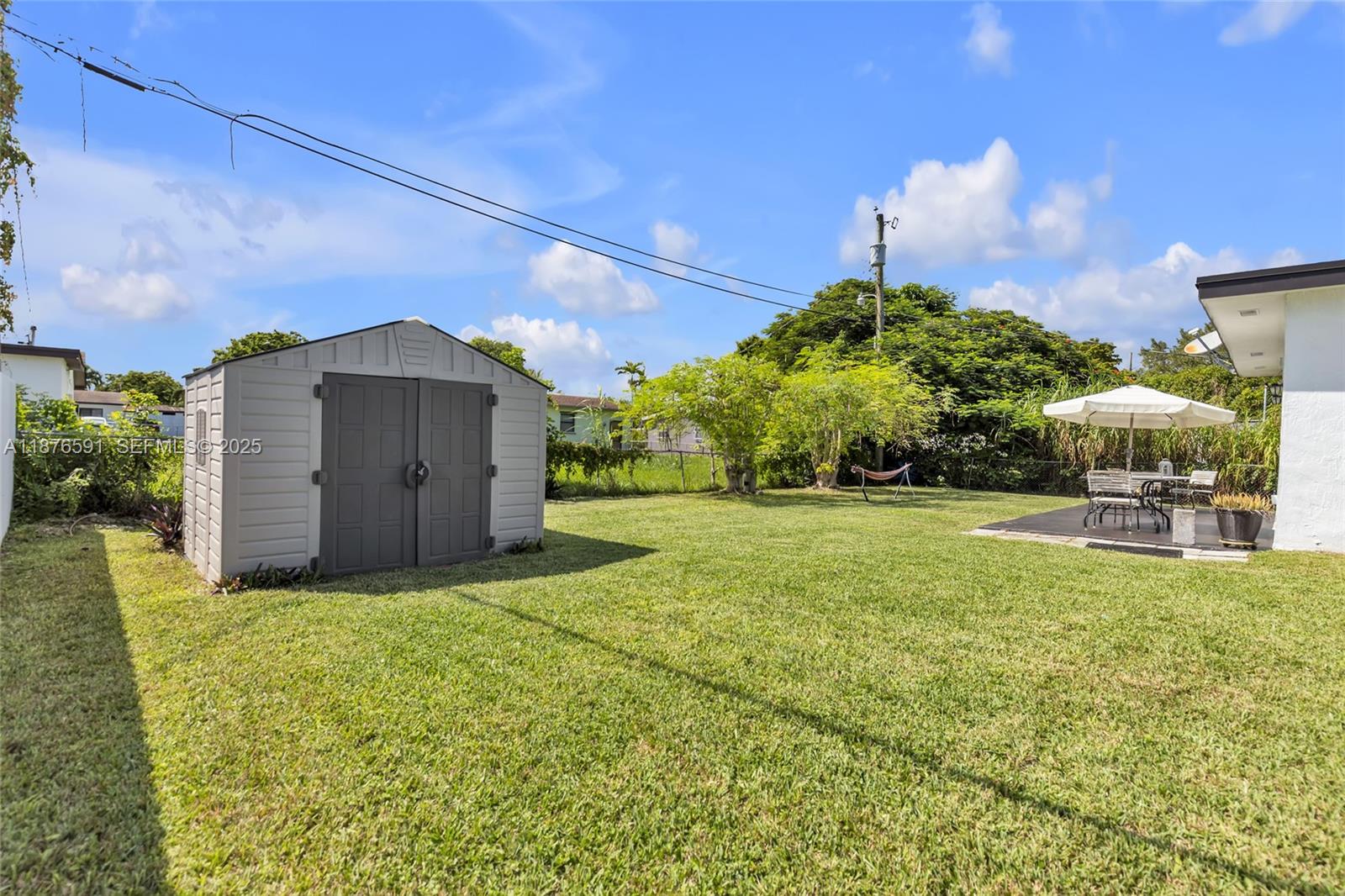 22270 Southwest 109th Avenue Miami, FL 33176 - Photo 45 of 48 a view of a back yard of the house with a yard