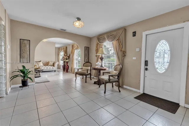 a living room with furniture a table and decor