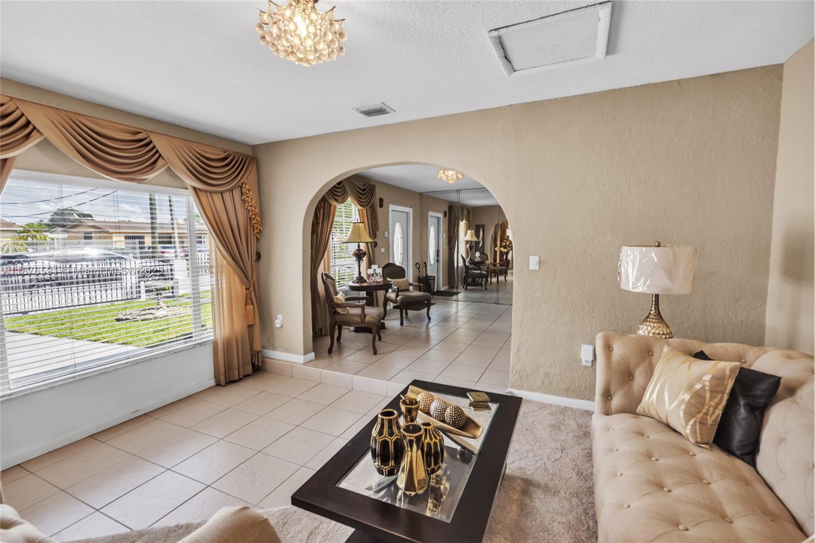22270 Southwest 109th Avenue Miami, FL 33176 - Photo 8 of 48 a living room with furniture and a large window