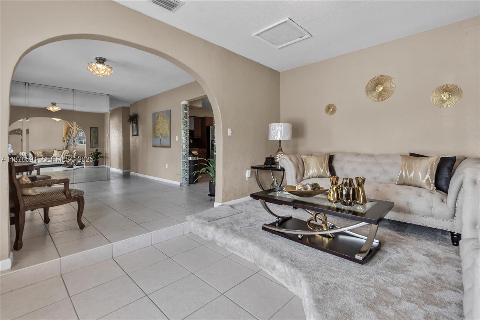 22270 Southwest 109th Avenue Miami, FL 33176 - Photo 9 of 48 a living room with furniture gym equipment and view of kitchen