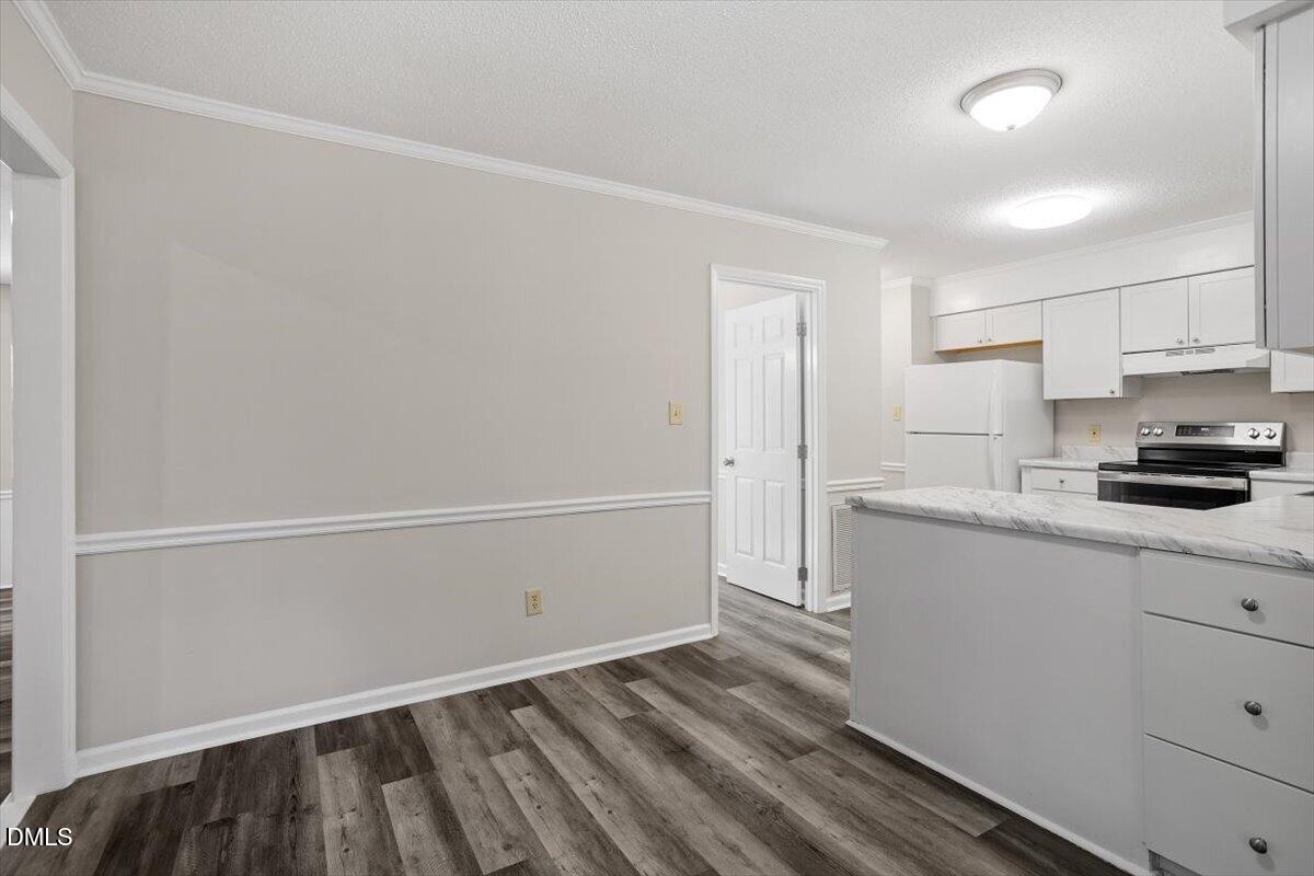 8233 Clear Brook Drive Raleigh, NC 27615 - Photo 11 of 28 a kitchen with a sink and cabinets