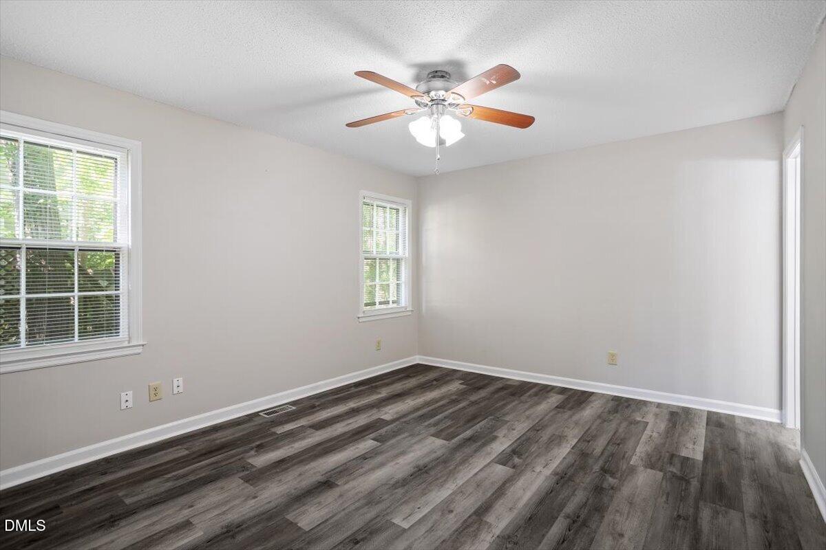 8233 Clear Brook Drive Raleigh, NC 27615 - Photo 16 of 28 a view of a room with wooden floor and windows