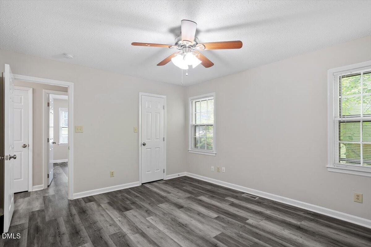 8233 Clear Brook Drive Raleigh, NC 27615 - Photo 17 of 28 wooden floor in an empty room with a window