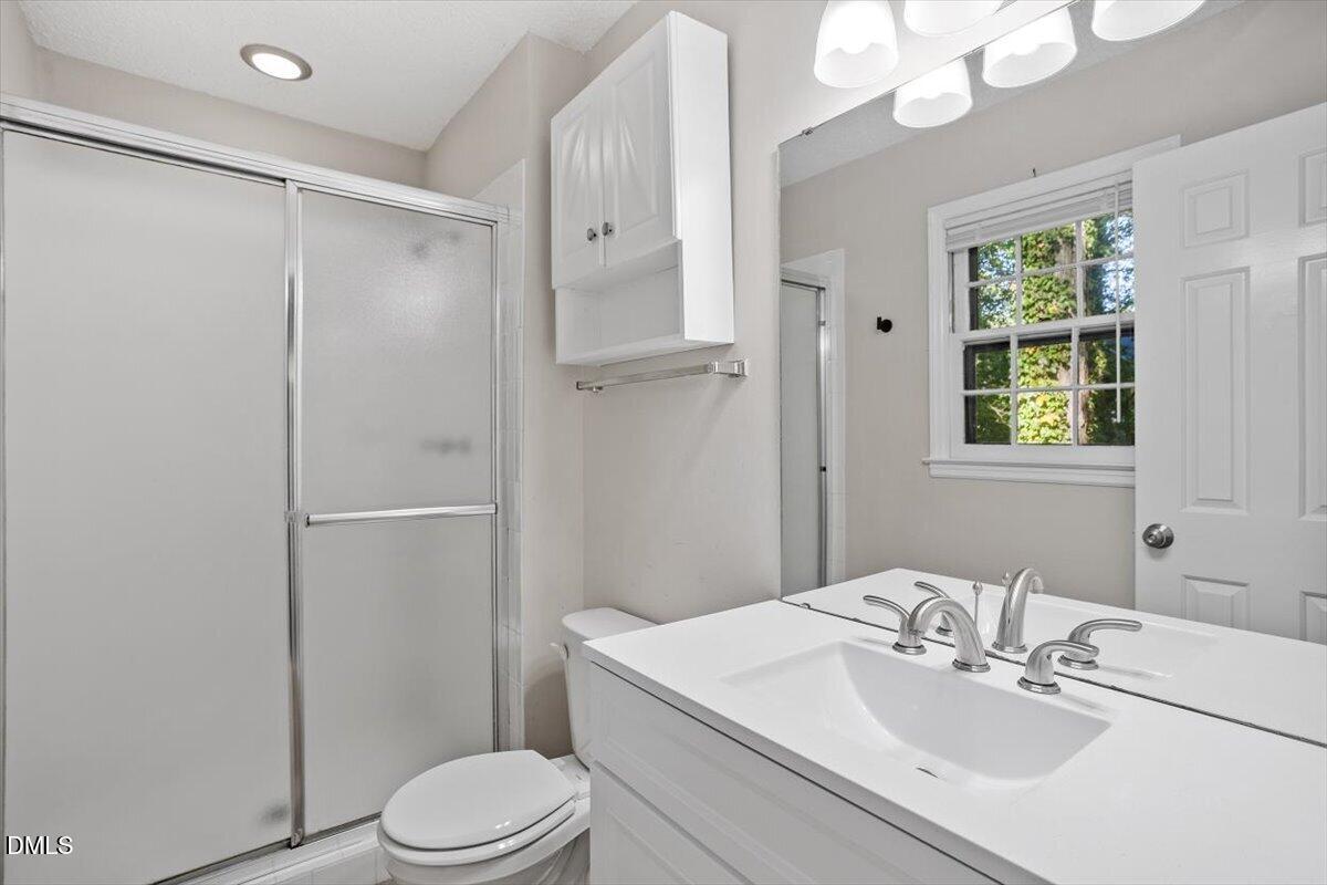 8233 Clear Brook Drive Raleigh, NC 27615 - Photo 19 of 28 a bathroom with a sink toilet and shower