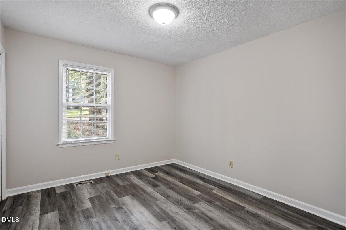 8233 Clear Brook Drive Raleigh, NC 27615 - Photo 20 of 28 an empty room with a window