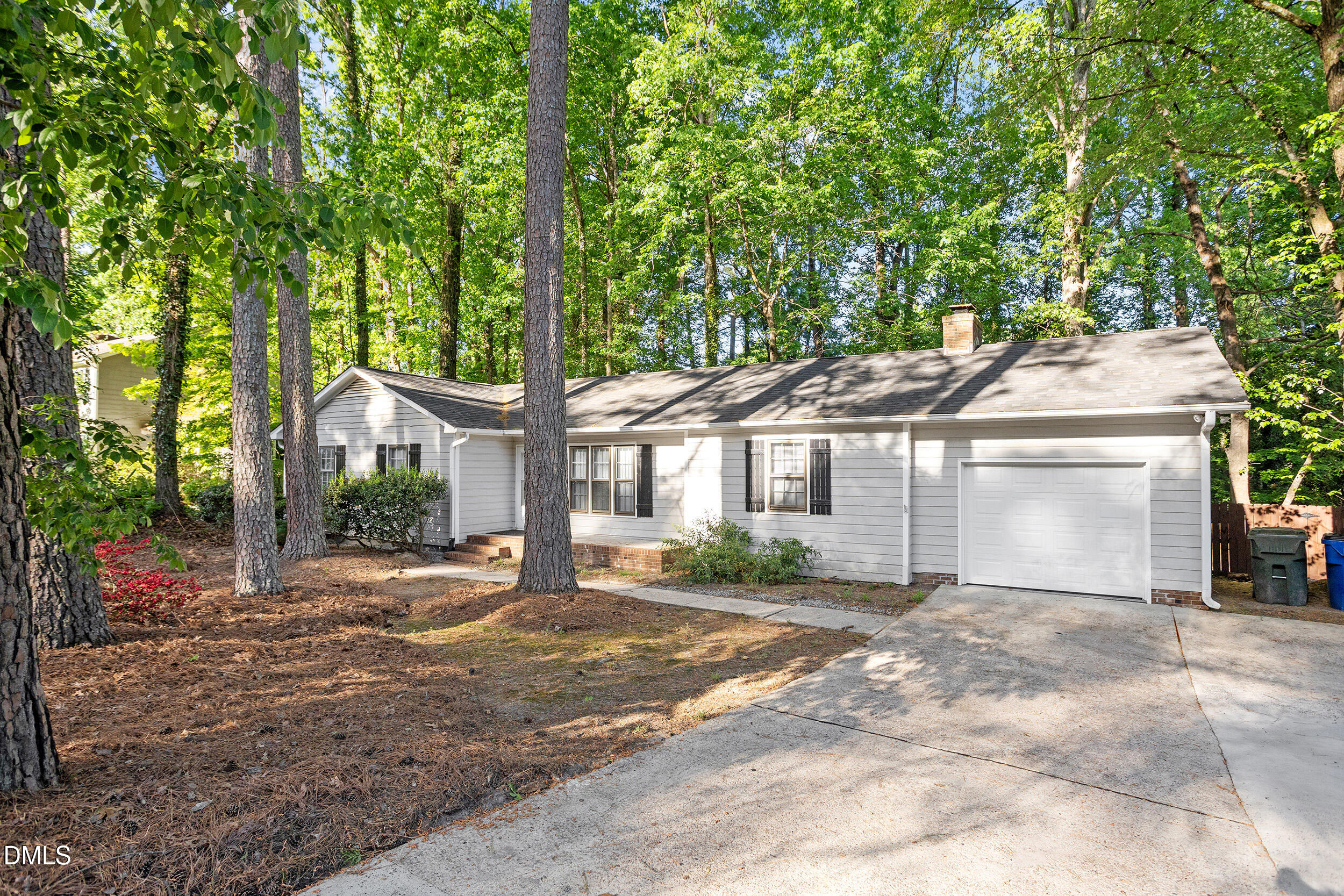 8233 Clear Brook Drive Raleigh, NC 27615 - Photo 2 of 28 a front view of a house with a garden