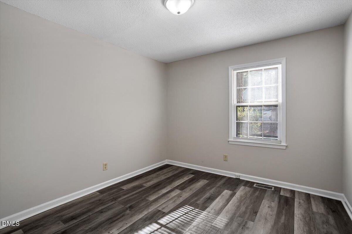 8233 Clear Brook Drive Raleigh, NC 27615 - Photo 23 of 28 an empty room with a window