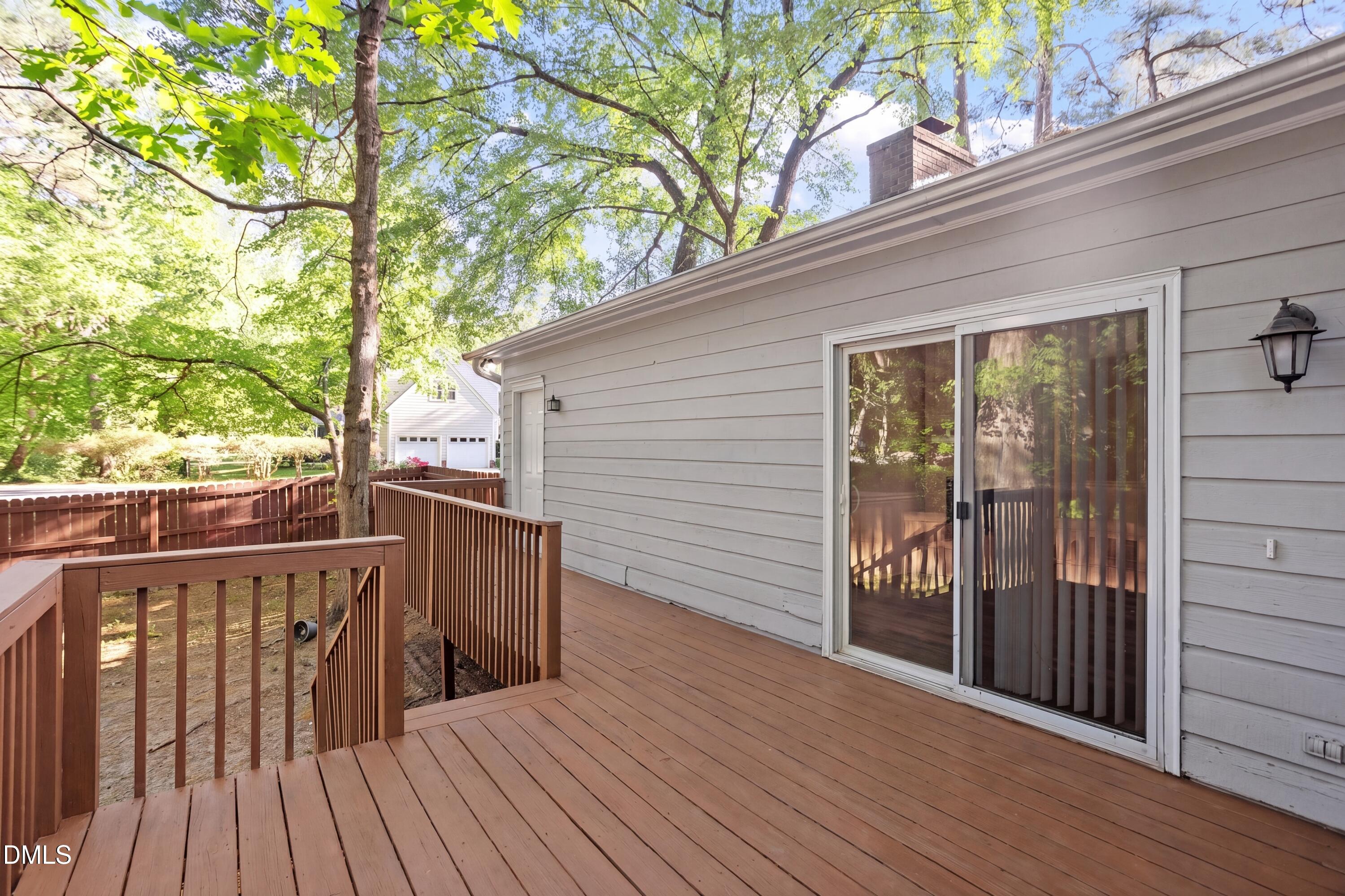 8233 Clear Brook Drive Raleigh, NC 27615 - Photo 25 of 28 a view of deck with wooden floor and fence and floor to ceiling window