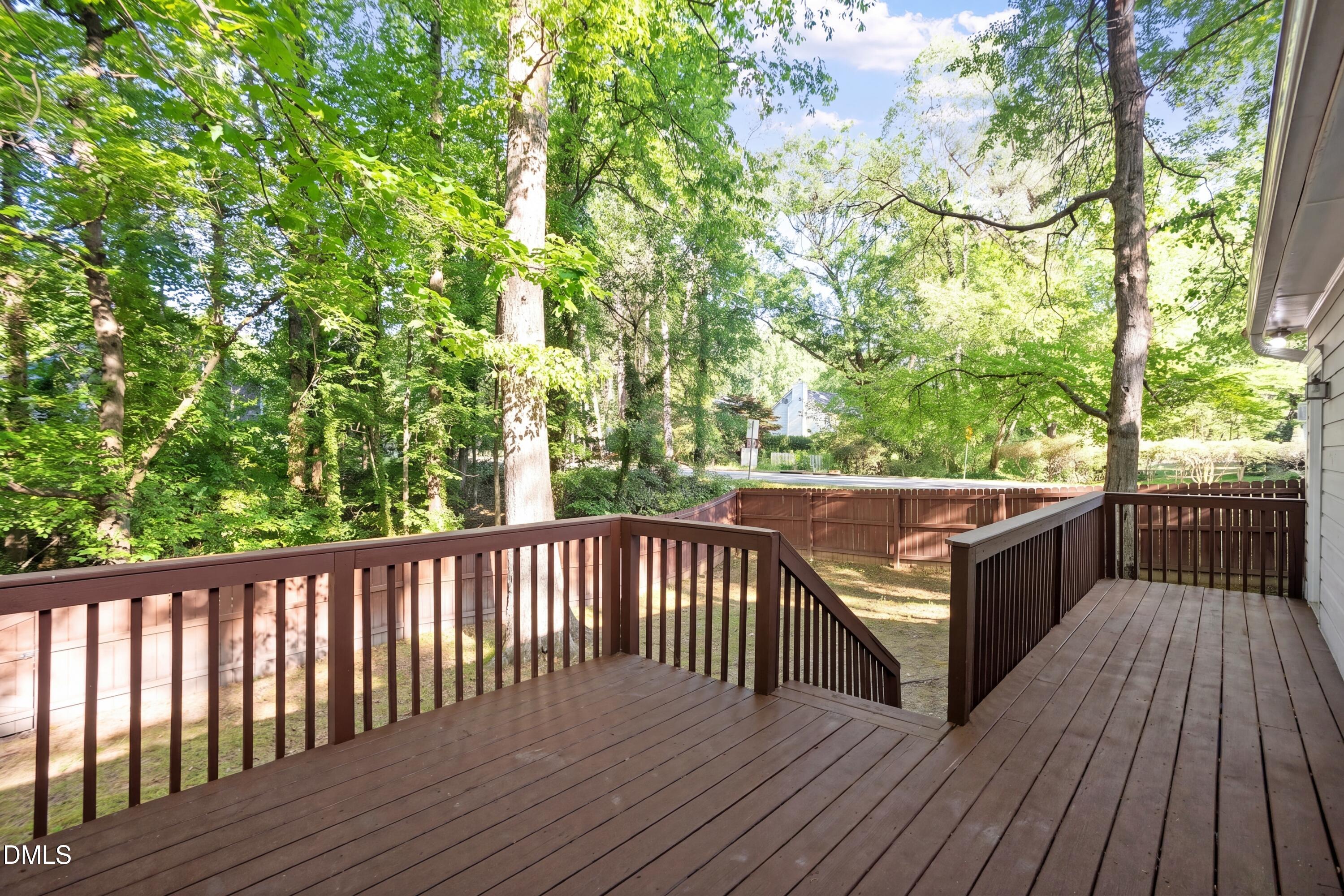8233 Clear Brook Drive Raleigh, NC 27615 - Photo 26 of 28 a balcony with wooden floor and fence