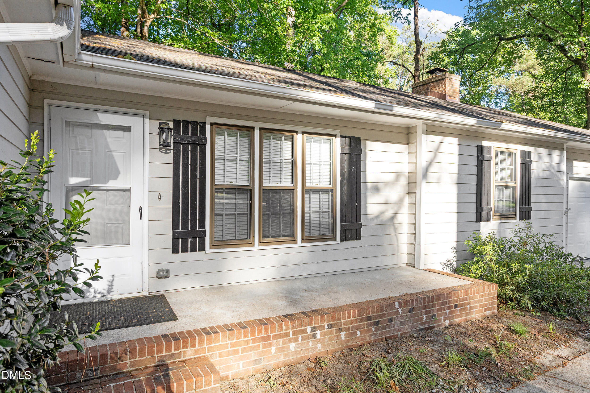 8233 Clear Brook Drive Raleigh, NC 27615 - Photo 3 of 28 a front view of a house with a garden