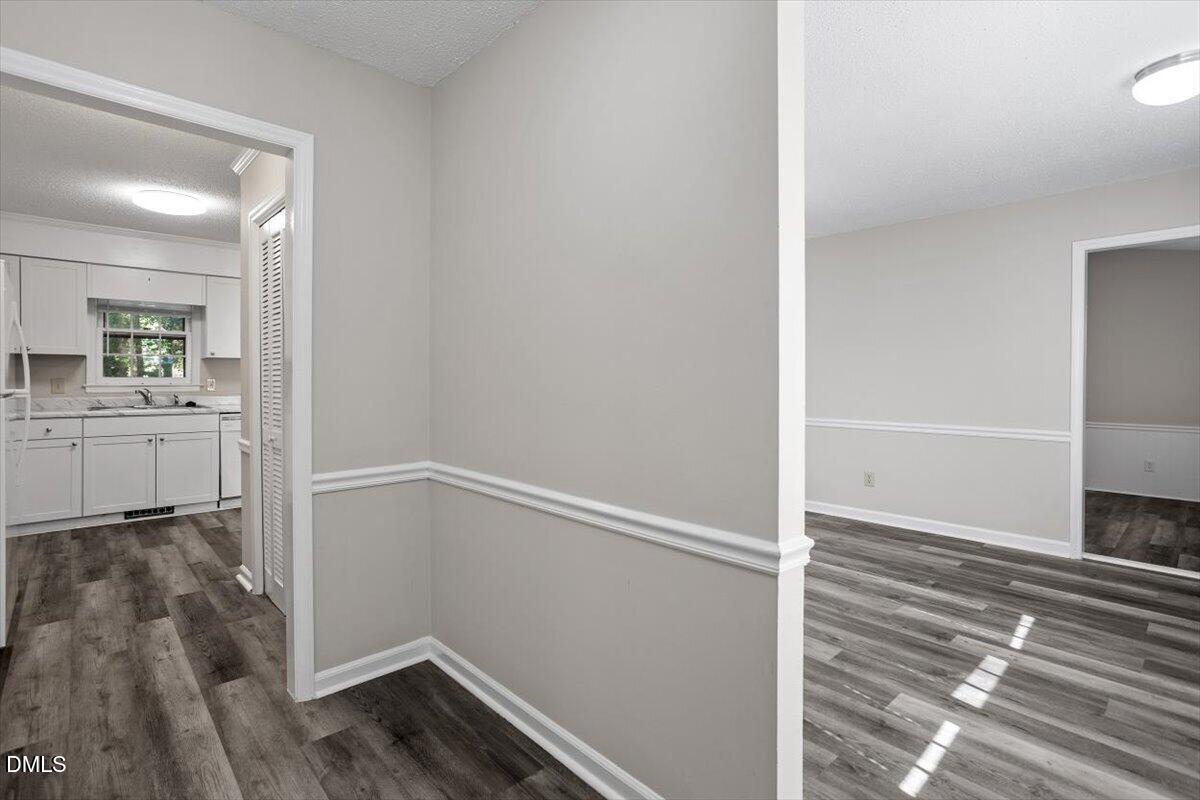 8233 Clear Brook Drive Raleigh, NC 27615 - Photo 4 of 28 wooden floor in an empty room with a window
