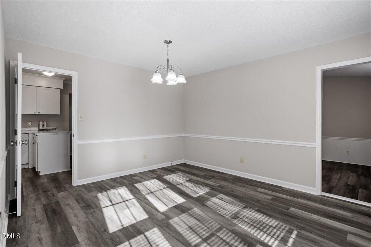 8233 Clear Brook Drive Raleigh, NC 27615 - Photo 5 of 28 a view of empty room with wooden floor