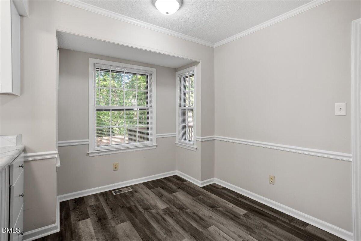 8233 Clear Brook Drive Raleigh, NC 27615 - Photo 10 of 28 a view of room with window and hardwood floor