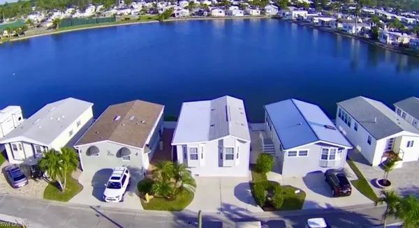 an aerial view of residential house with outdoor space and trees all around