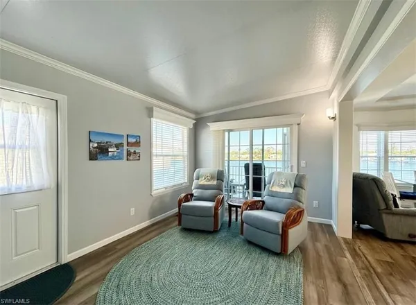 a view of a dining room with furniture window and wooden floor