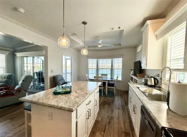a kitchen with stainless steel appliances granite countertop a sink a stove and refrigerator