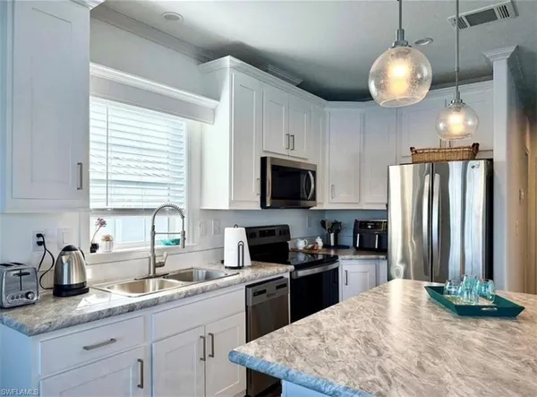 a kitchen with a refrigerator stove and sink