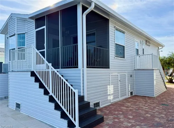 a view of a house with wooden deck