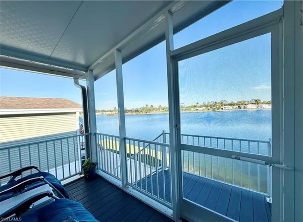a view of a lake with houses in the back