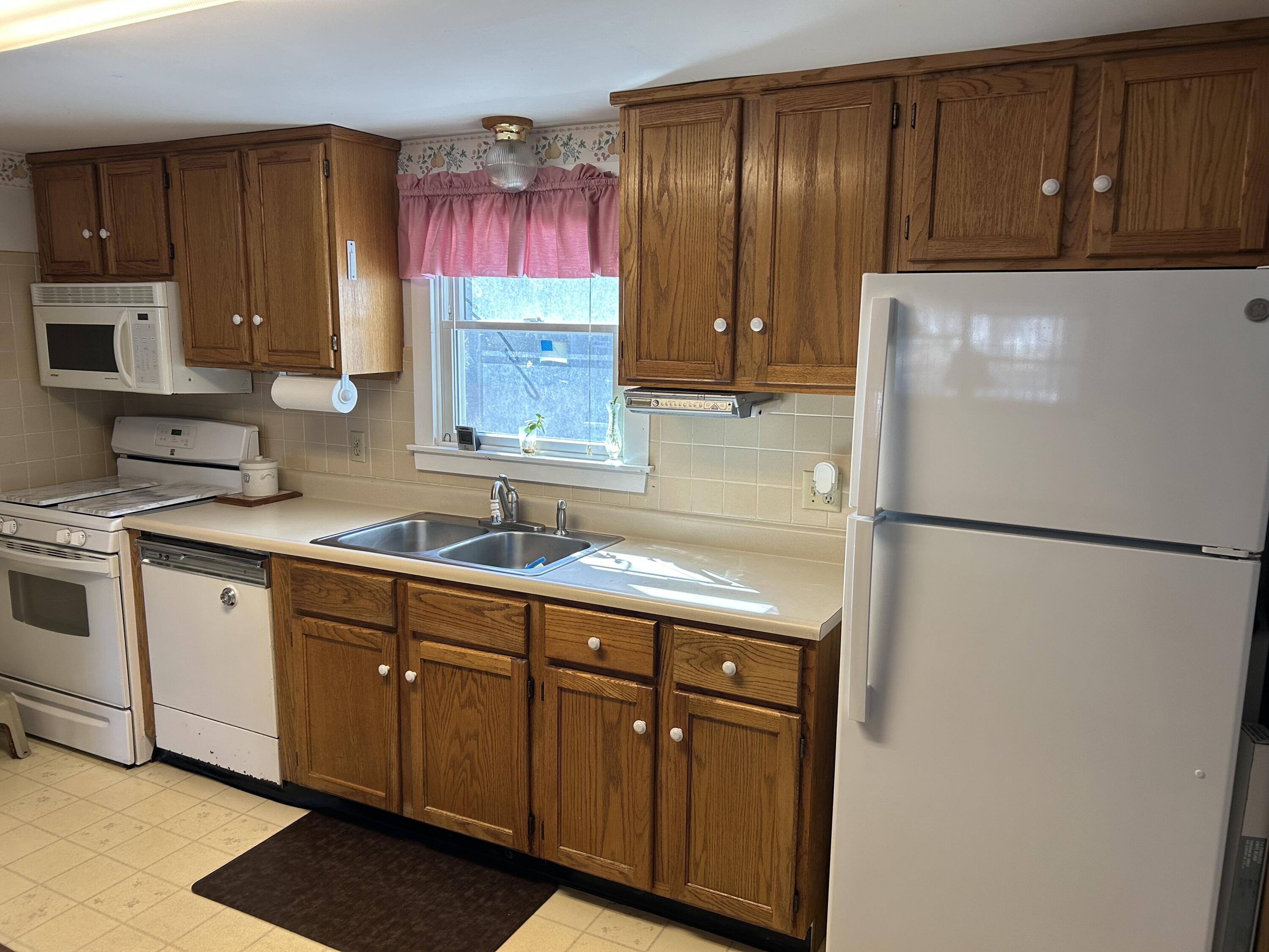 7 Delta Street Hyannis, MA 02601 - Photo 9 of 29 a kitchen with a refrigerator sink and cabinets