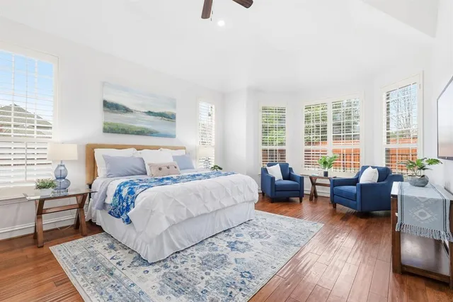a spacious bathroom with a double vanity sink a large mirror and a shower