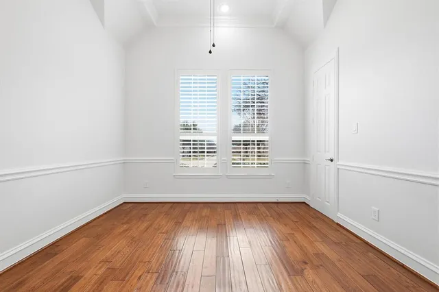 a room with a wooden floor and shelf