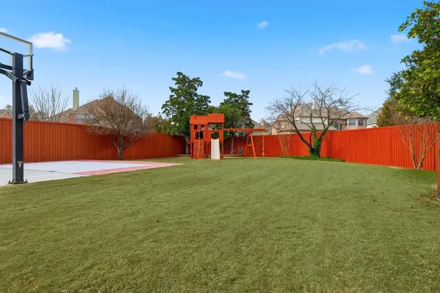 an aerial view of a house with a yard basket ball court and outdoor seating