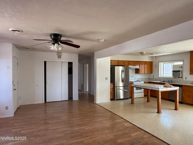 a view of a room with a table and chairs