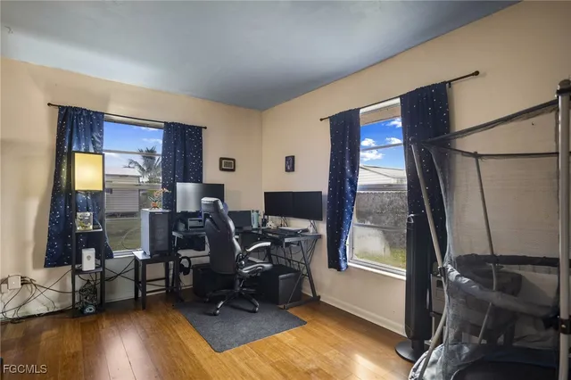 a view of a workspace with furniture and a window