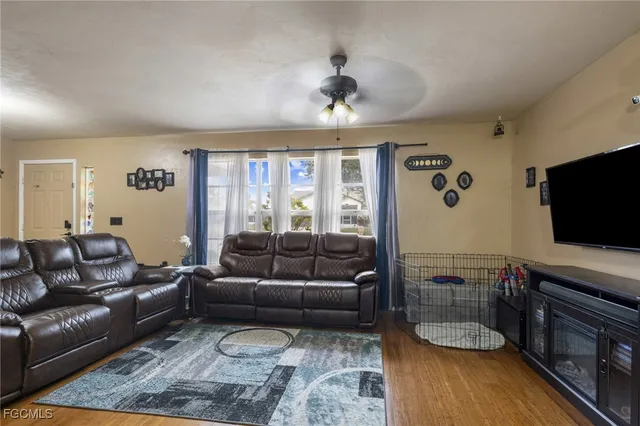 a living room with furniture and a flat screen tv