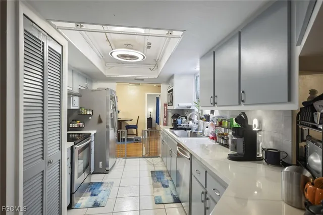 a kitchen with stainless steel appliances granite countertop a stove sink and cabinets