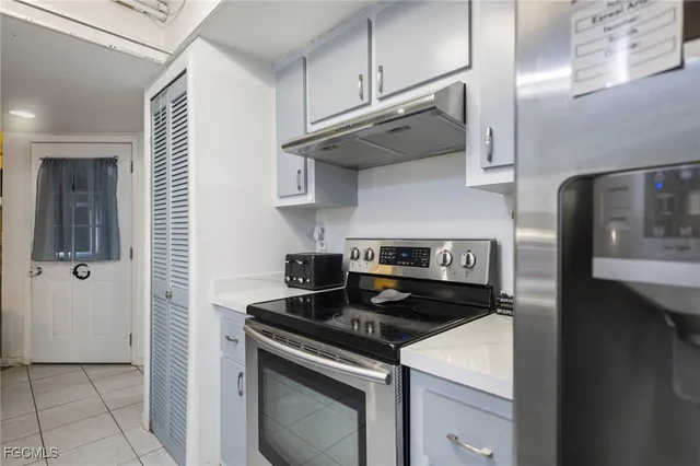 a kitchen with stainless steel appliances granite countertop a stove and a refrigerator