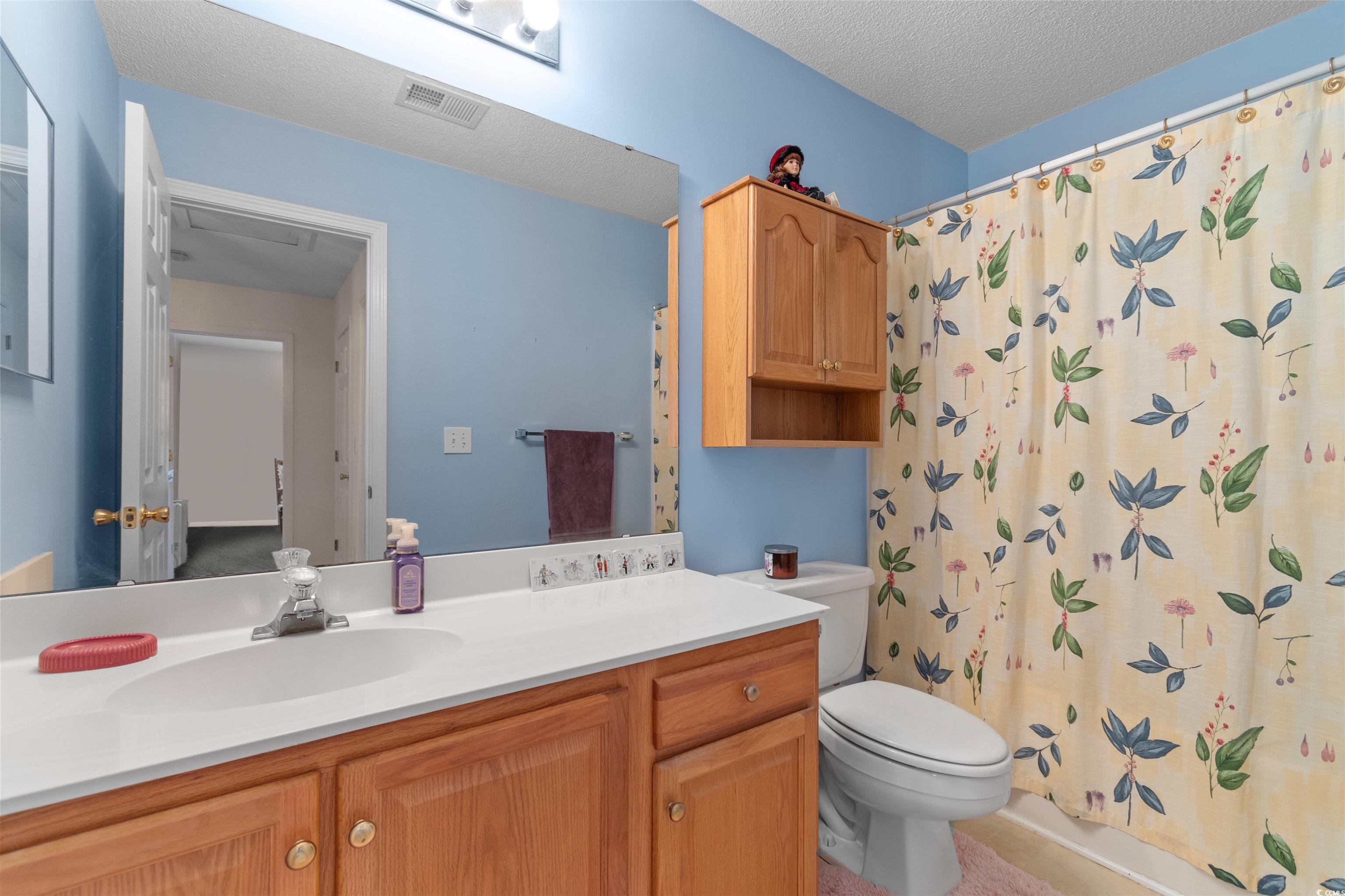 155 Wimbledon Way, Unit 155 Murrells Inlet, SC 29576 - Photo 18 of 32 Bedroom featuring carpet, connected bathroom, and