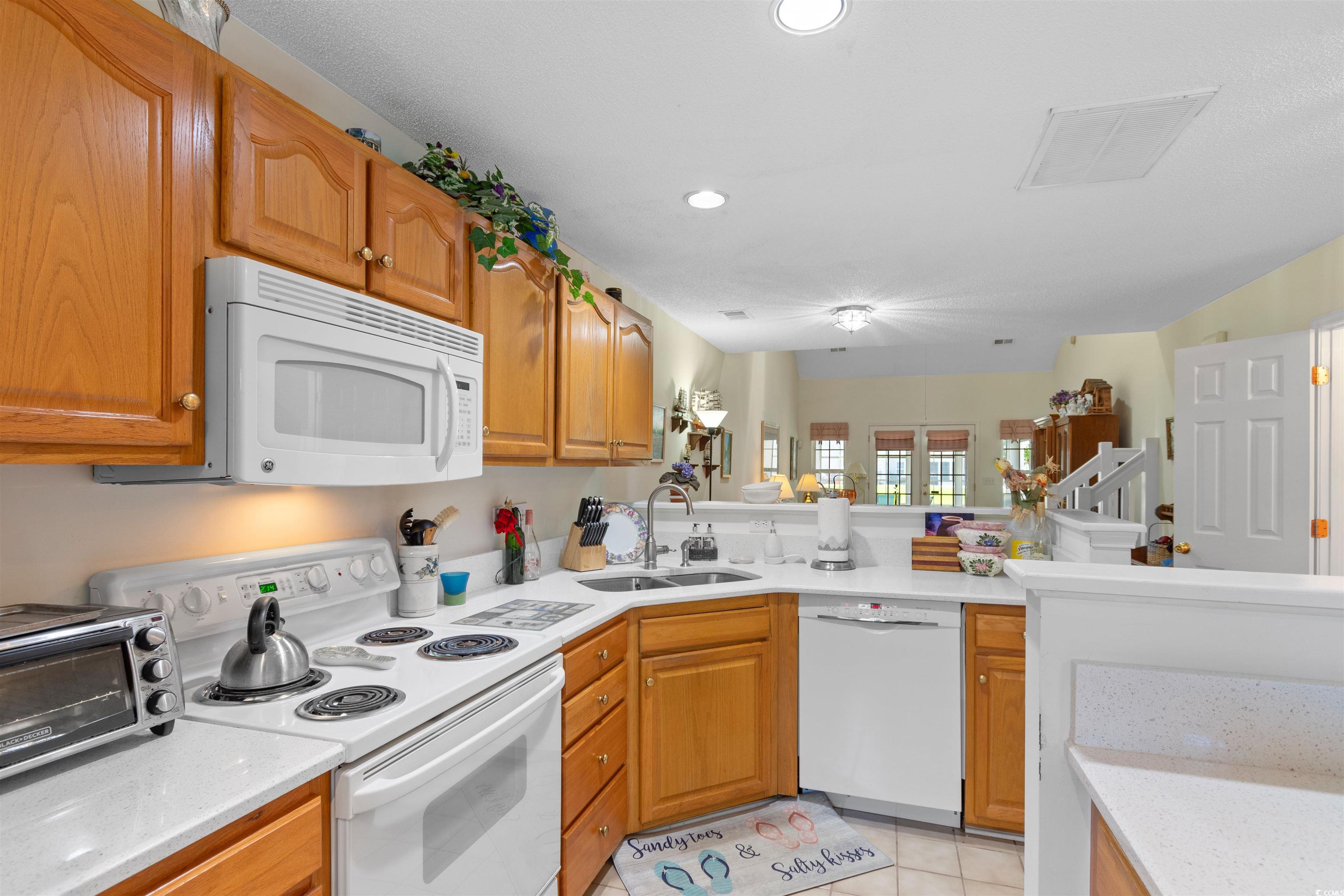 155 Wimbledon Way, Unit 155 Murrells Inlet, SC 29576 - Photo 7 of 32 Kitchen with kitchen peninsula, sink, light tile p