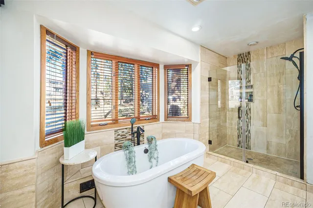 a bathroom with a tub sink and mirror