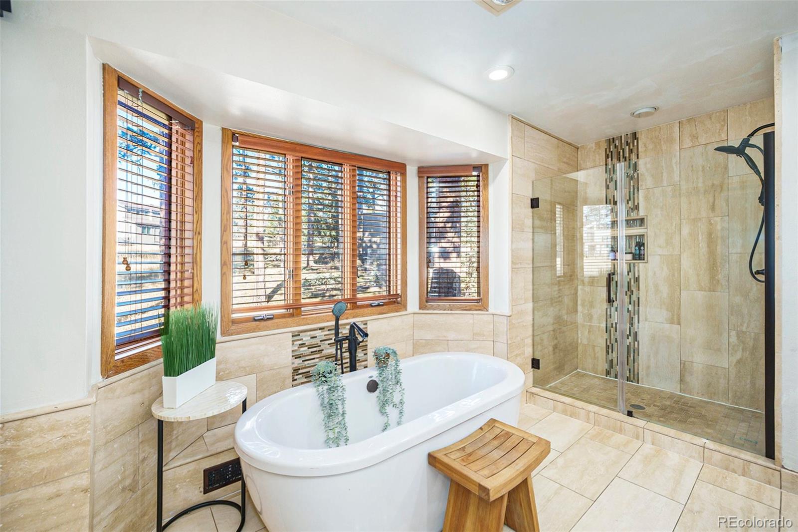 23526 Currant Drive Golden, CO 80401 - Photo 13 of 30 a bathroom with a tub sink and mirror