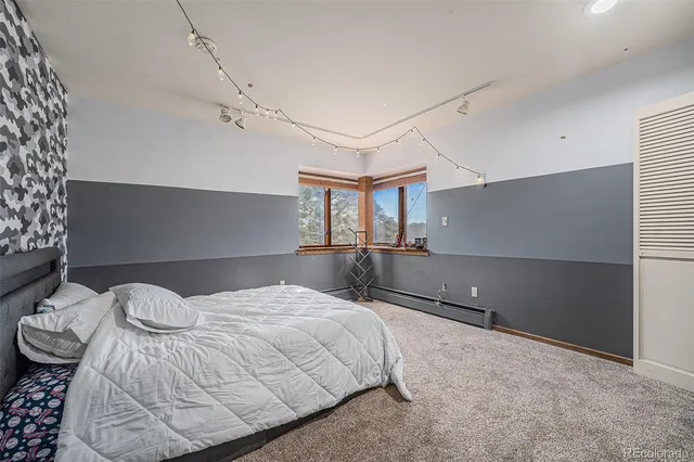 a bedroom with a bed and a chandelier
