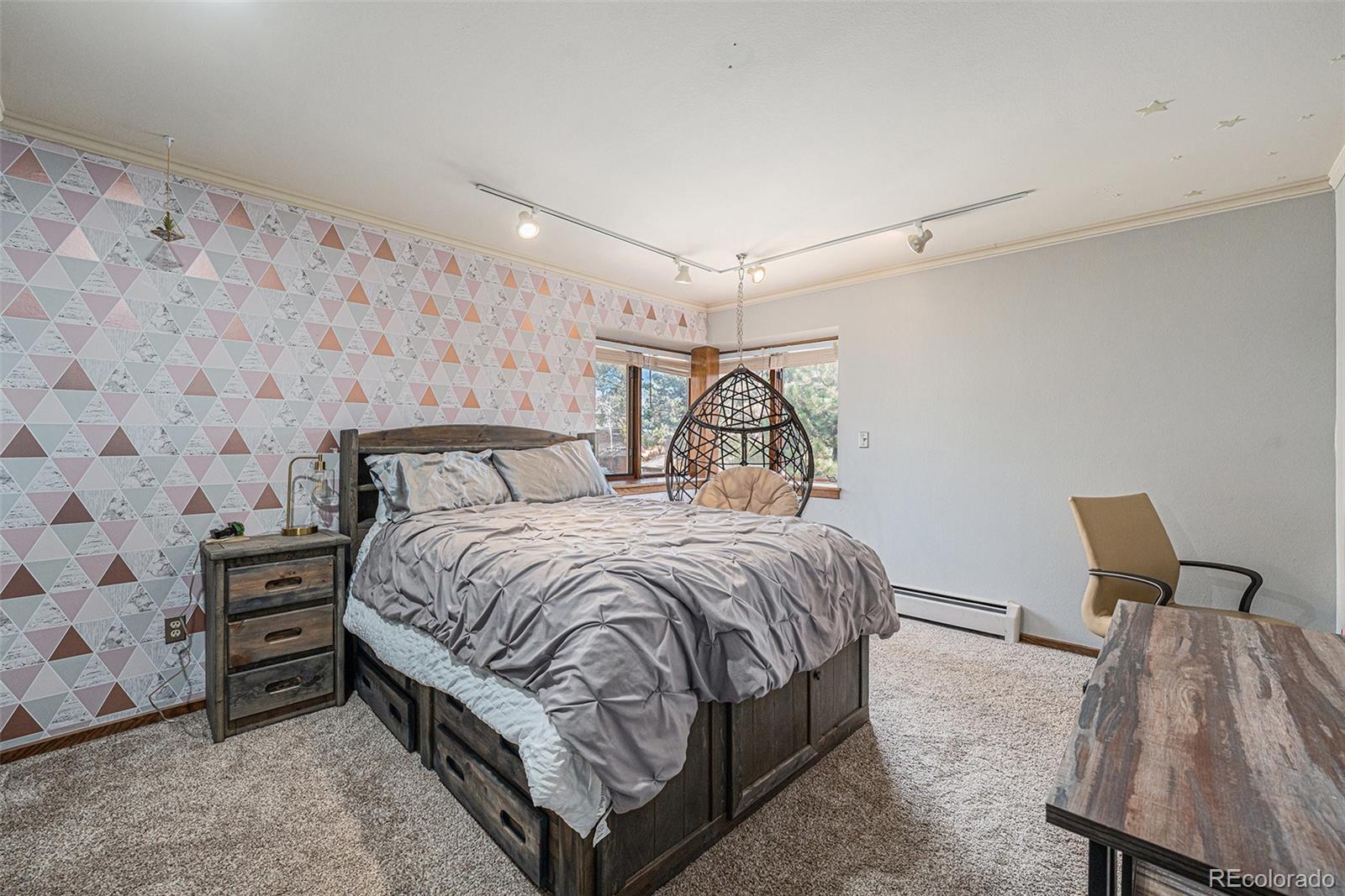 23526 Currant Drive Golden, CO 80401 - Photo 16 of 30 a bedroom with a bed and a chair