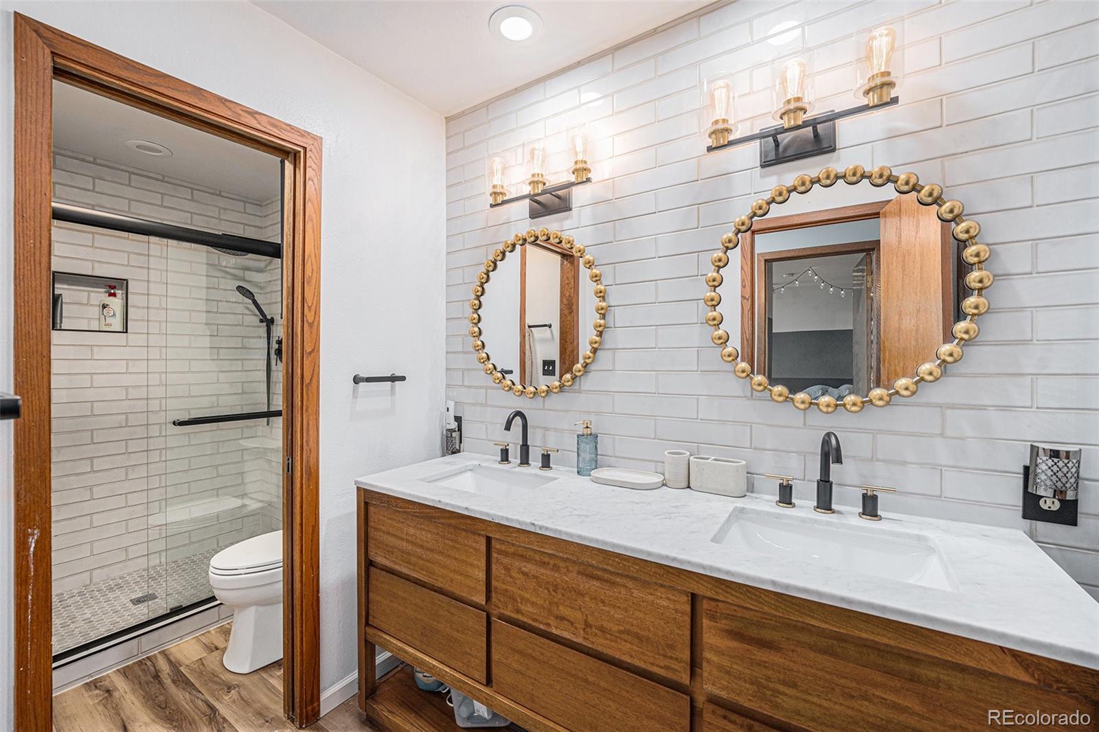 23526 Currant Drive Golden, CO 80401 - Photo 17 of 30 a bathroom with a double vanity sink and a mirror
