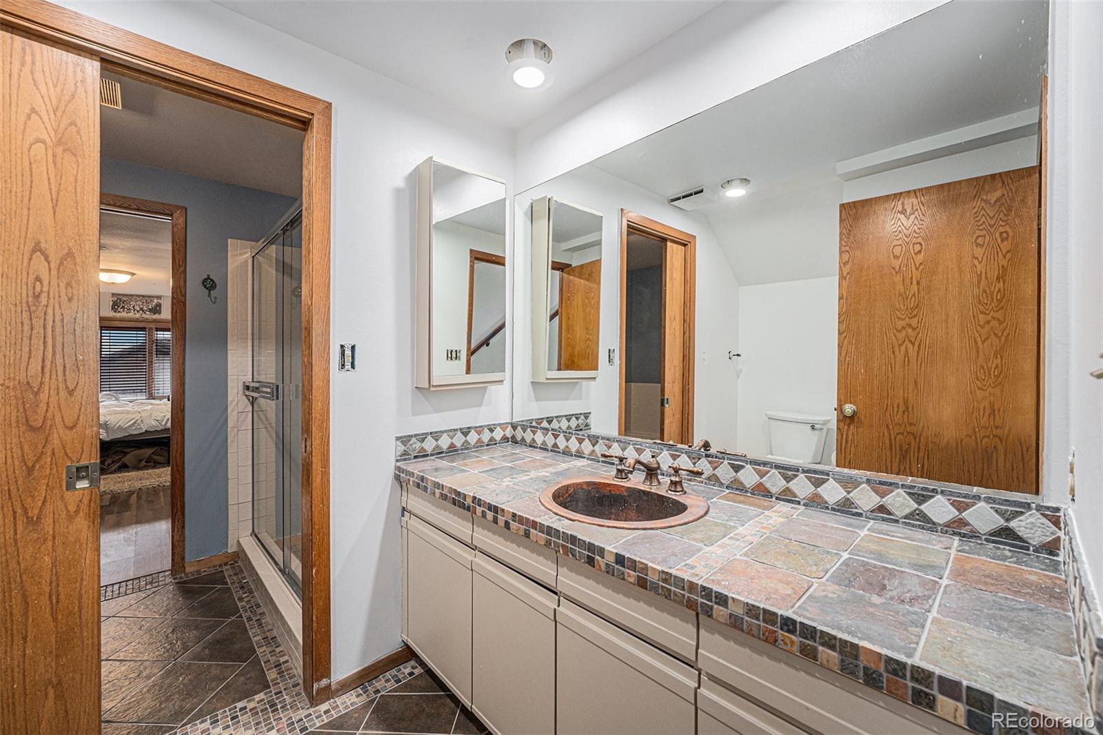 23526 Currant Drive Golden, CO 80401 - Photo 23 of 30 a bathroom with a sink and a mirror