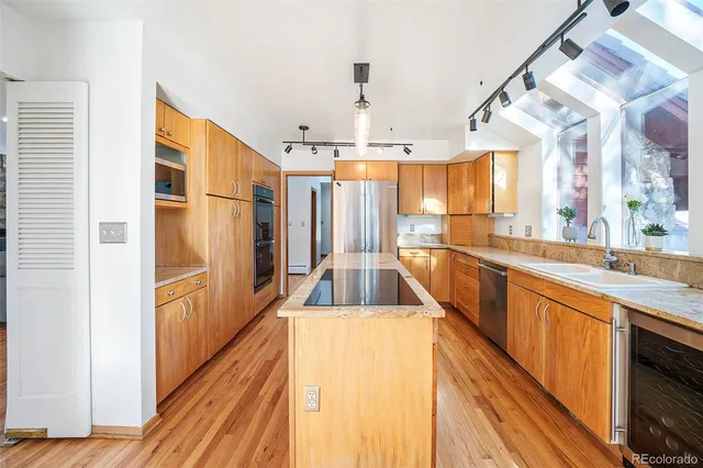 a kitchen with stainless steel appliances a sink and cabinets
